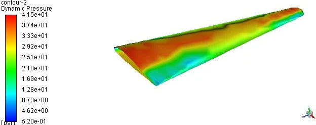 CFD dynamic pressure contour over the aircraft wing showing the high-energy flow region across the upper surface